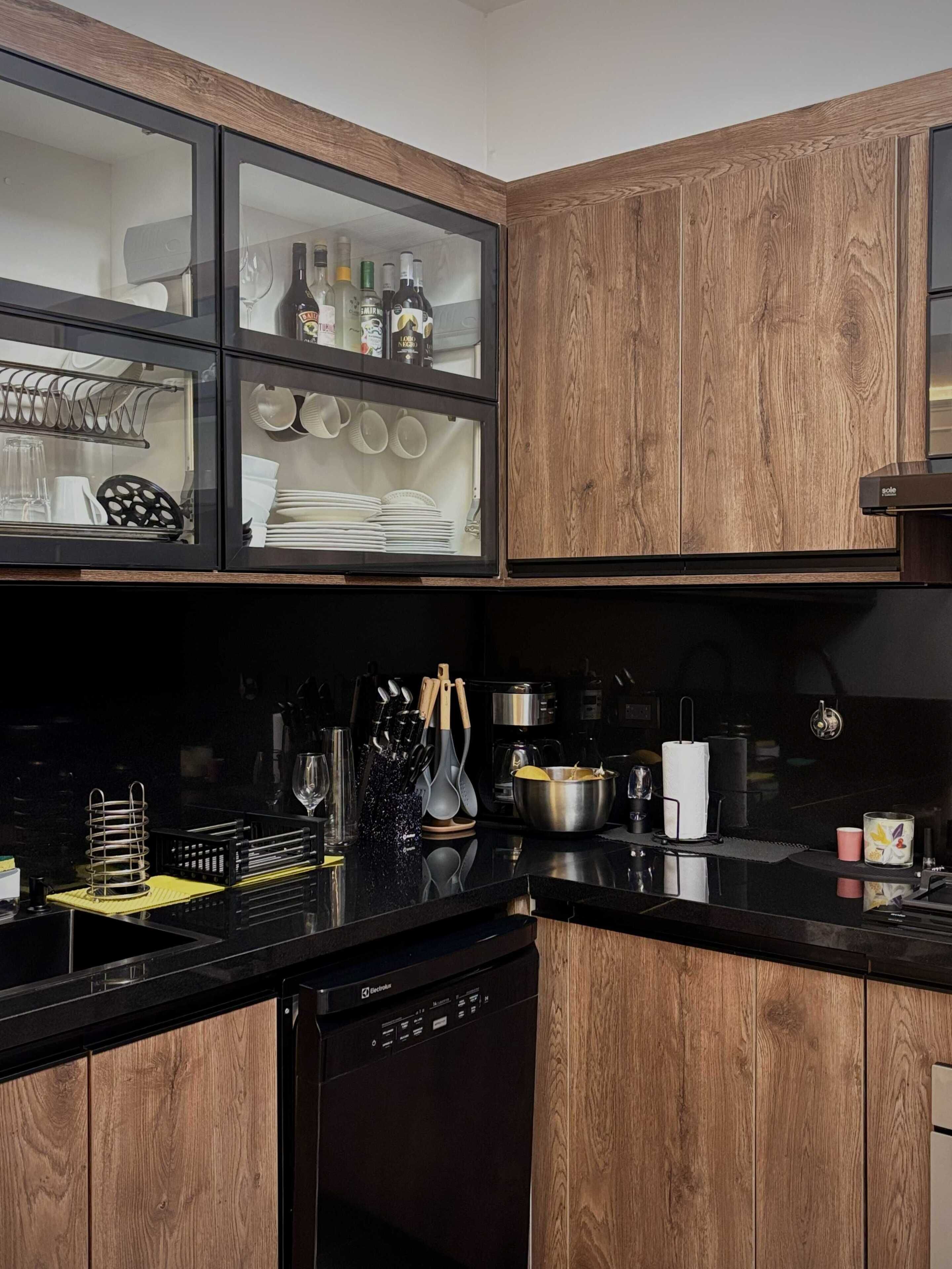 A modern kitchen with wooden cabinetry, a dishwasher, and various kitchen utensils and appliances.