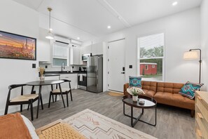 A modern apartment with a kitchen, dining area, and living room. - Modern Boxabl Casita Stillwater OK Pasadera 6 (Stillwater)