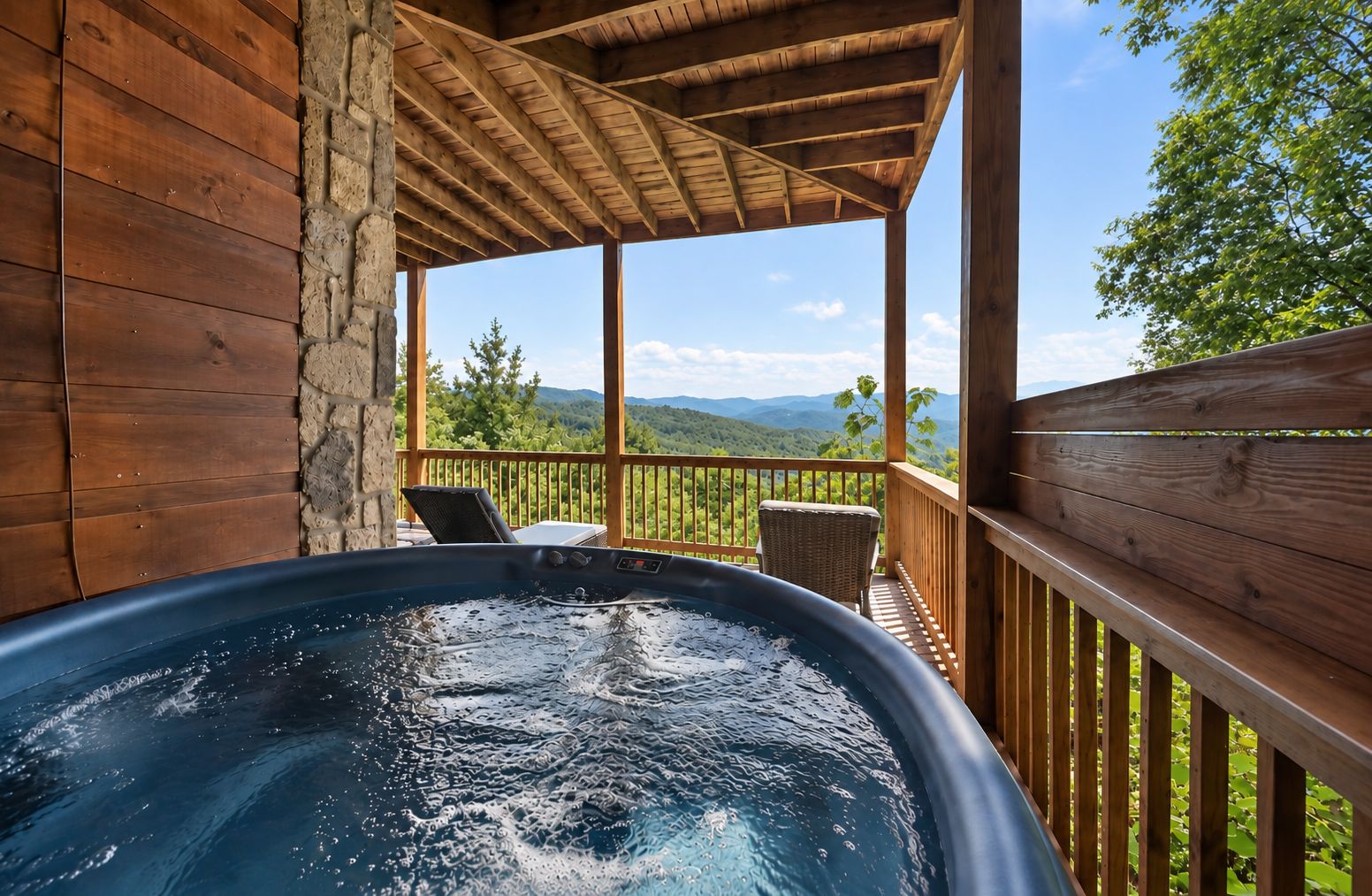 A hot tub on a wooden deck with a view of a mountainous landscape.