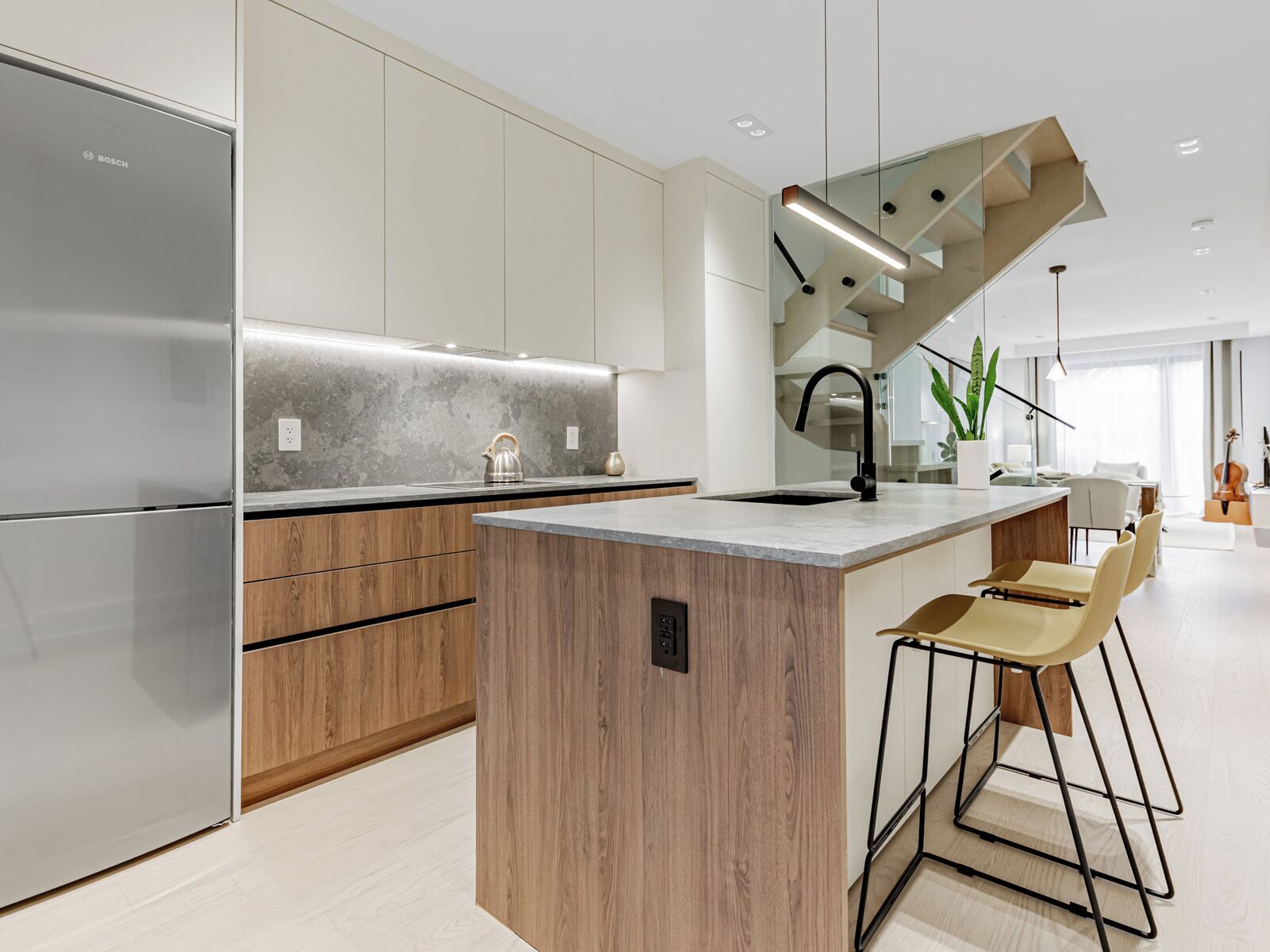A modern kitchen with a built-in island, stainless steel appliances, and a minimalist design.