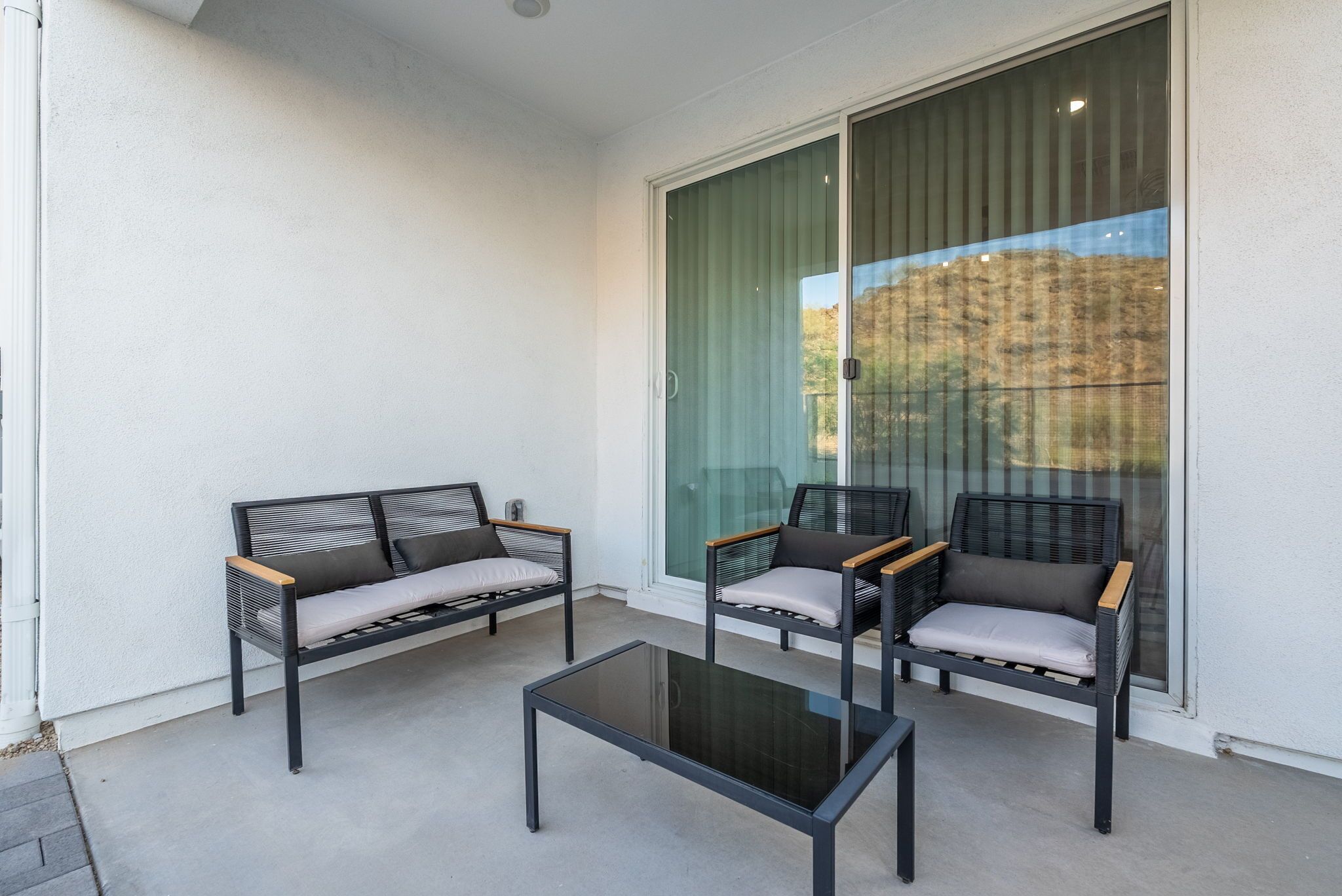 A balcony with two sofas and a coffee table.
