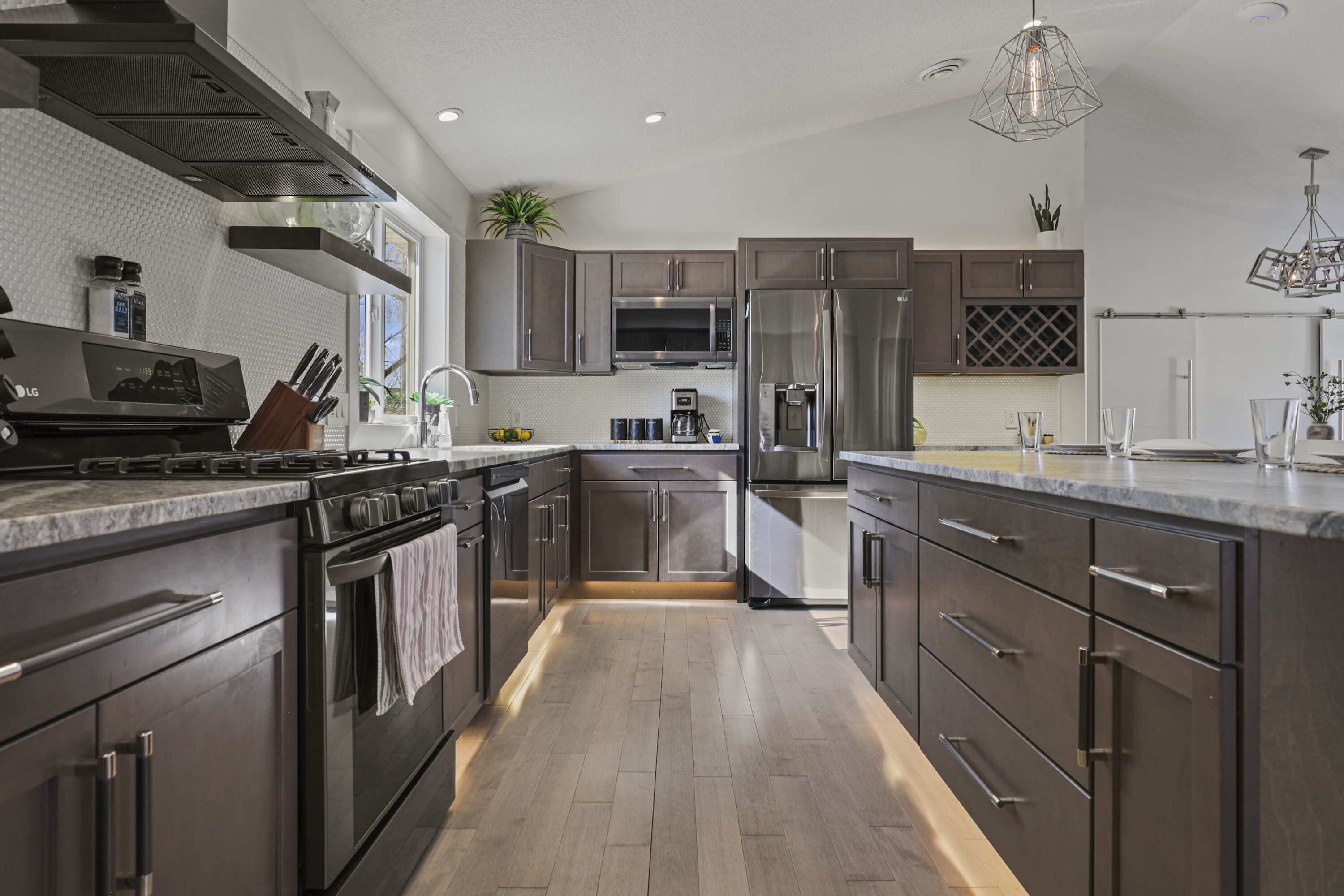 A modern kitchen with stainless steel appliances, a built-in oven, and a microwave.