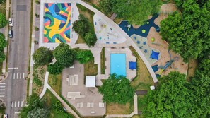 An aerial view of a park with a basketball court, playground, and a swimming pool. - 10min to US Bank Stadium & U of M w/ Fireplace (Minneapolis)
