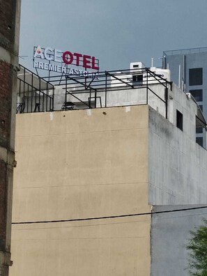 A building with a sign that reads 'AGE HOTEL PREMIERASTONIA.' - Aceotel Premier Astoria Indore (Indore)