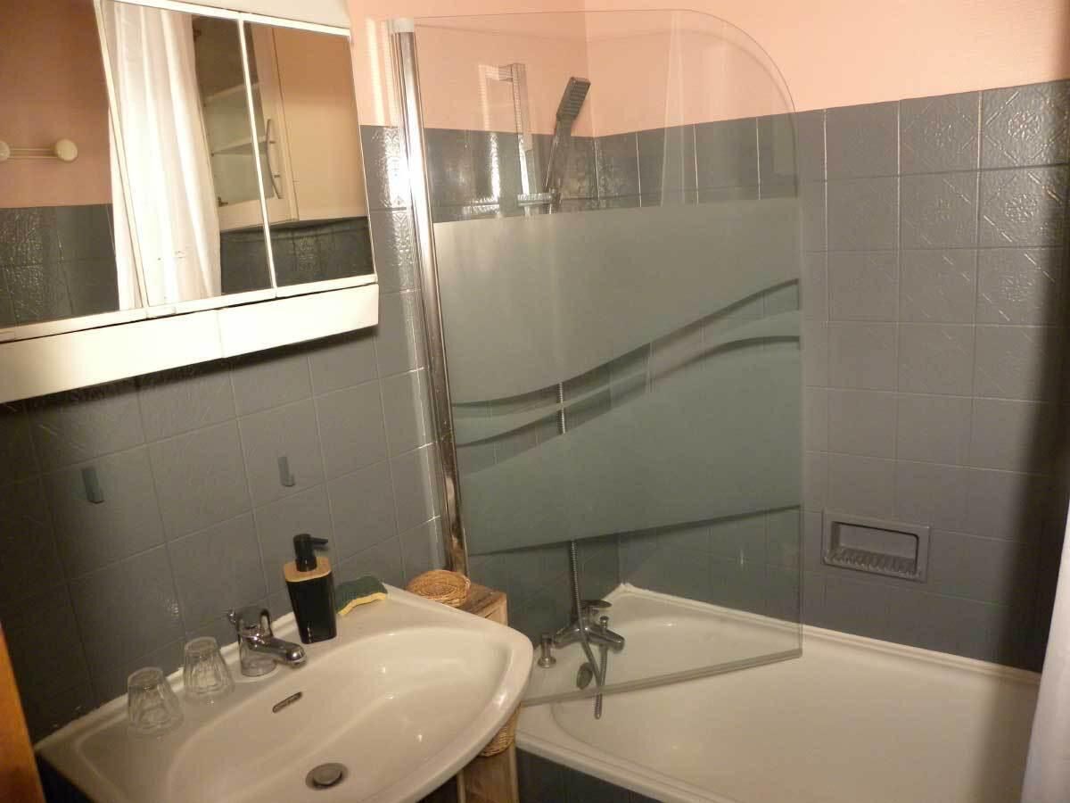 A bathroom with two sinks, a bathtub, and a shower enclosure.