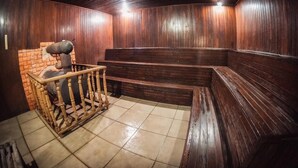 A room with wooden paneling, a brick wall, and a bench area.