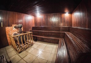 A room with wooden paneling, a brick wall, and a bench area.