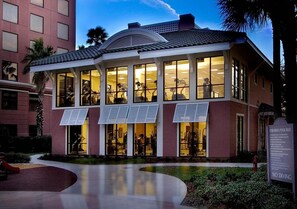 A building with large windows, a covered outdoor area, and a sign indicating no diving. - Queen Suite at Caribe Royale Orlando - Sports Court & Resort Fun Included! (Orlando)