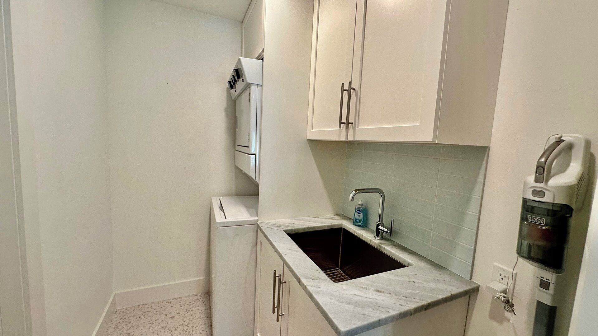 A small kitchen with a sink, a microwave, and a coffee maker.
