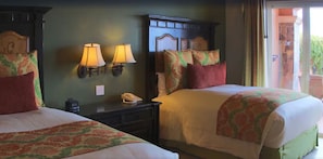 A hotel room with two beds, a nightstand with a telephone, and wall-mounted lamps. - Beautiful Oceanview Villa at Pueblo Bonito (Cabo San Lucas)