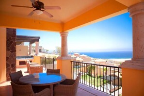 A balcony with a table and chairs, overlooking a coastal view. - Montecristo Villa with Oceanviews (Cabo San Lucas)