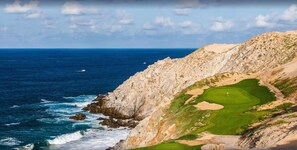 A coastal landscape with a rocky cliff and a golf course. - Montecristo Villa with Oceanviews (Cabo San Lucas)