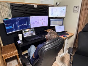 A workspace with multiple monitors, a laptop, and a smartphone on a desk. - Davish house (Hialeah)