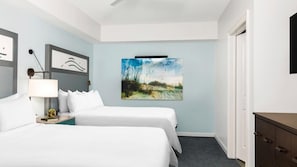 A hotel room with two beds, a nightstand, a lamp, a painting, and a dresser. - Coastal SurfWatch Getaway with Ocean Vista & Spacious 2BR Comfort (Hilton Head Island)
