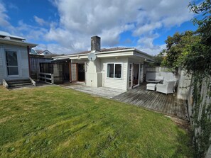 A residential property with a covered patio, a satellite dish, and a fenced yard. - Middleton Near The Beach (Paraparaumu Beach)