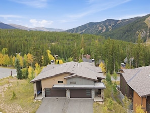 A modern two-story house with a garage, surrounded by a forested mountain landscape. - Alpine Retreat Near Winter Park Resort (Winter Park)