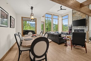 A spacious living area with a dining table, sofas, and a fireplace. - Alpine Retreat Near Winter Park Resort (Winter Park)