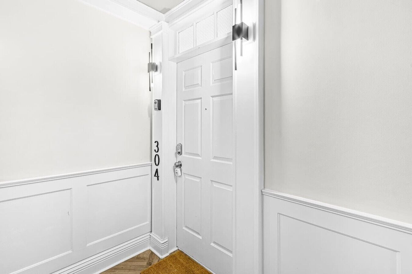 A white door with a number '304' and a modern handle.