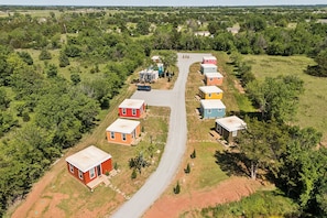 A residential area with a main road and several colorful houses. - Modern Boxabl Casita | Stillwater OK | Pasadera 9 (Stillwater)