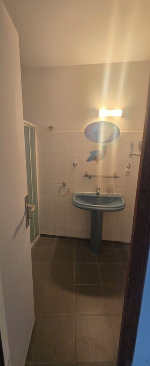 Ein Badezimmer mit Waschbecken, Spiegel und Handtuchhalter.