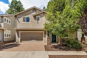 A two-story house with a garage, a brick driveway, and a well-maintained lawn. - 2 Suite to be good! Escape to the Mountains! (Flagstaff)