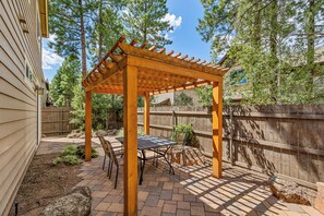 A covered patio area with a pergola, outdoor seating, and a wooden fence. - 2 Suite to be good! Escape to the Mountains! (Flagstaff)