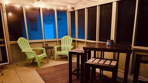 A room with a table and two chairs, a small rug, and a window with a view of a building. - Pet-Friendly Home Near Dragon Con & Downtown (Atlanta)