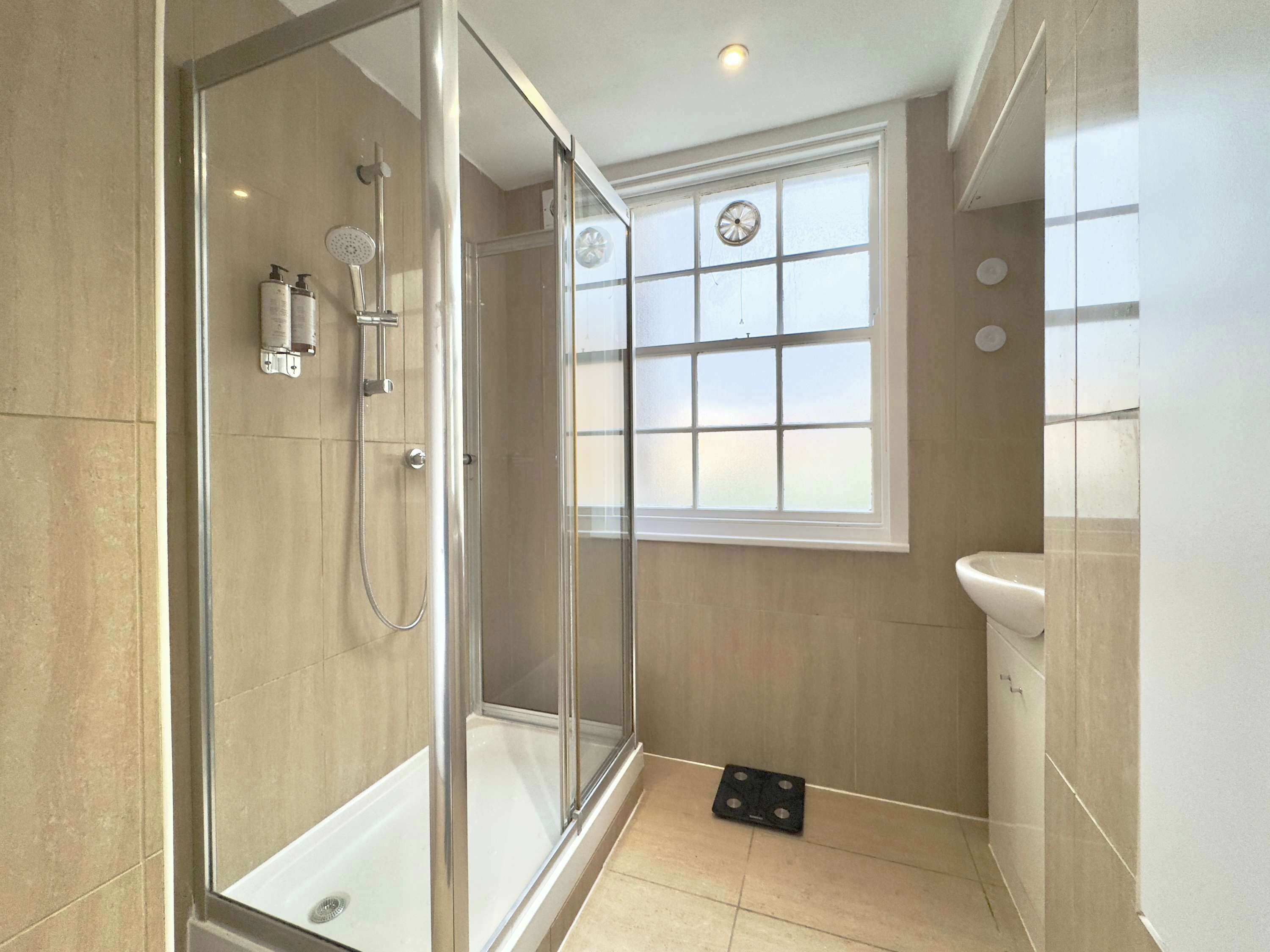 Shower, hair dryer, towels, shampoo