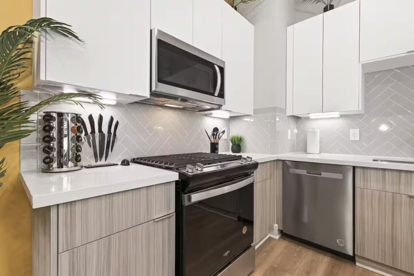 A modern kitchen with a built-in microwave, stove, and dishwasher.