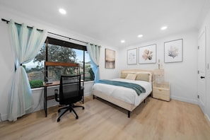 A bedroom with a bed, desk, chair, and a window with curtains. - Pool, Big Yard, View, King Bed, Parking, 4BR - 2.5Bth (El Cajon)
