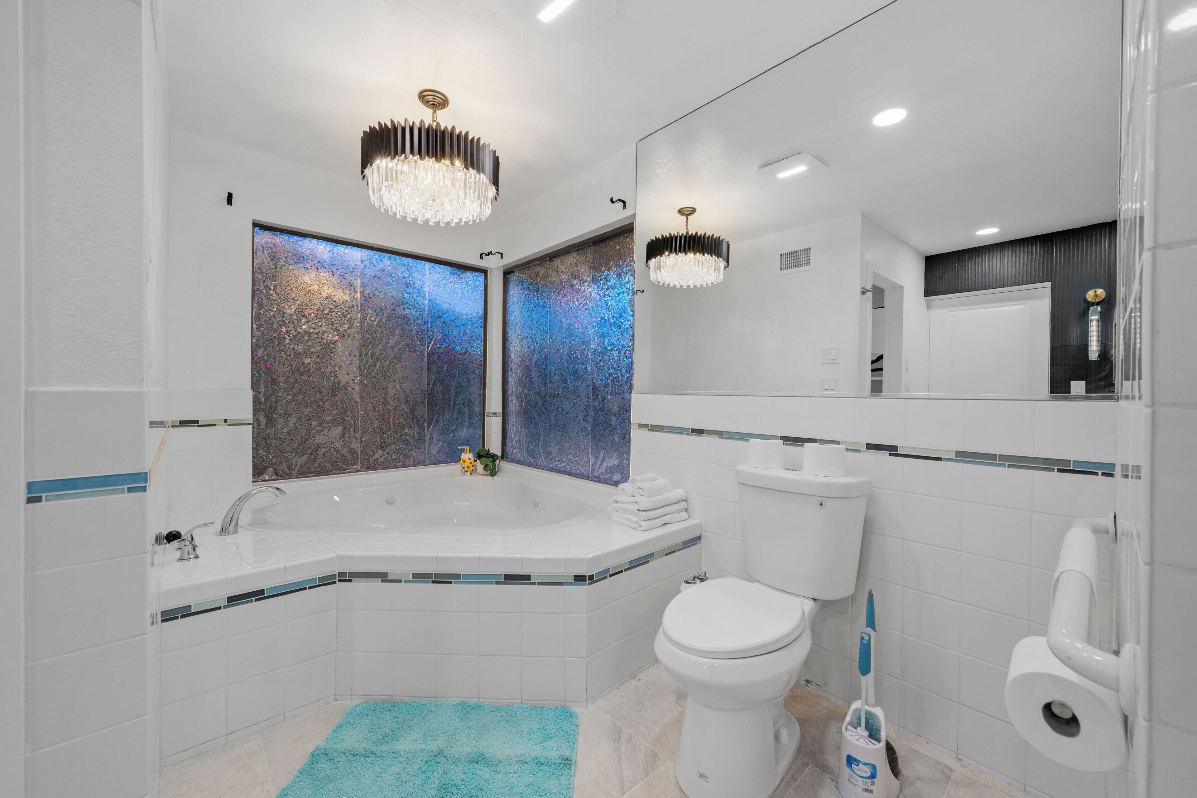 A modern bathroom with a freestanding bathtub, a toilet, and a sink.