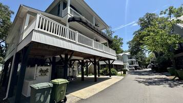 A two-story building with a balcony and a covered outdoor area.