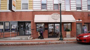 A brick building with a sign for 'radish & rye FOOD HUB' at the entrance. - cozy elegant efficiency (Harrisburg)