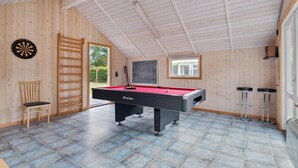 A room with a pool table, a dartboard, a chair, and a window. - Holiday home by Limfjord, Storvorde (Storvorde)