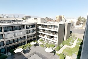 A modern building with multiple floors, balconies, and a rooftop garden. - Contemporary, comfortable apartment with WiFi and air conditioning (Santiago)