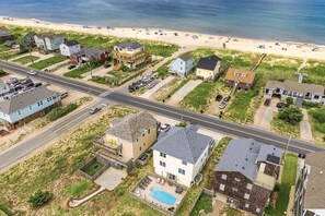 A coastal residential area with houses, a road, and a beach. - Avalon Alibi | 300 ft to the beach | Private Pool, Hot Tub, and Pool Table (Kill Devil Hills)
