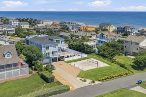 A coastal residential area with houses, a clear sky, and the ocean in the background. - Sea To Sound | 740 ft to the beach | Private Pool, Hot Tub, and Dog Friendly (Duck)