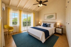 A bedroom with a bed, a chair, a nightstand, a ceiling fan, and a window with curtains. - Spacious 7-bedroom estate in pleasant Saint James with AC (Saint James)