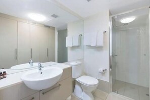 Ein Badezimmer mit Waschbecken, Toilette und einer Duschkabine.