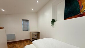 A small, clean room with a bed, a small desk, a radiator, a window, and a plant. - Brand New! (Cardiff)