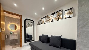 A modern bathroom with a vanity, mirror, and a large mirror above the sofa. - Brand New! (Cardiff)