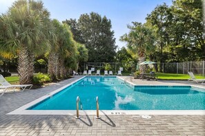 A rectangular swimming pool with a 5 ft depth marker, surrounded by lounge chairs and palm trees. - 3BR Old Village Retreat - Extended Stay w/ Pool (Mount Pleasant)