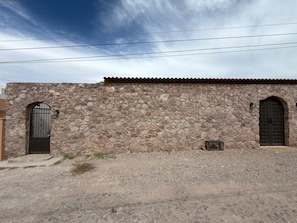 A stone building with two arched doors and a gravel driveway. - Private infinity pool & Jacuzzi 4BR Oceanfront (San Carlos)