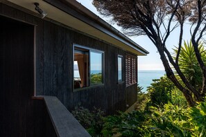 A modern building with large windows overlooking a body of water.