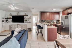 A modern kitchen with a built-in island, stainless steel appliances, and wooden cabinets.
