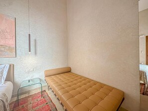 A small, single-bed room with a plain wall, a bedside table, and a hanging light fixture. - The Green Room at Riad Timija: En-suite, Breakfast & Rooftop in the Medina (Marrakesh)