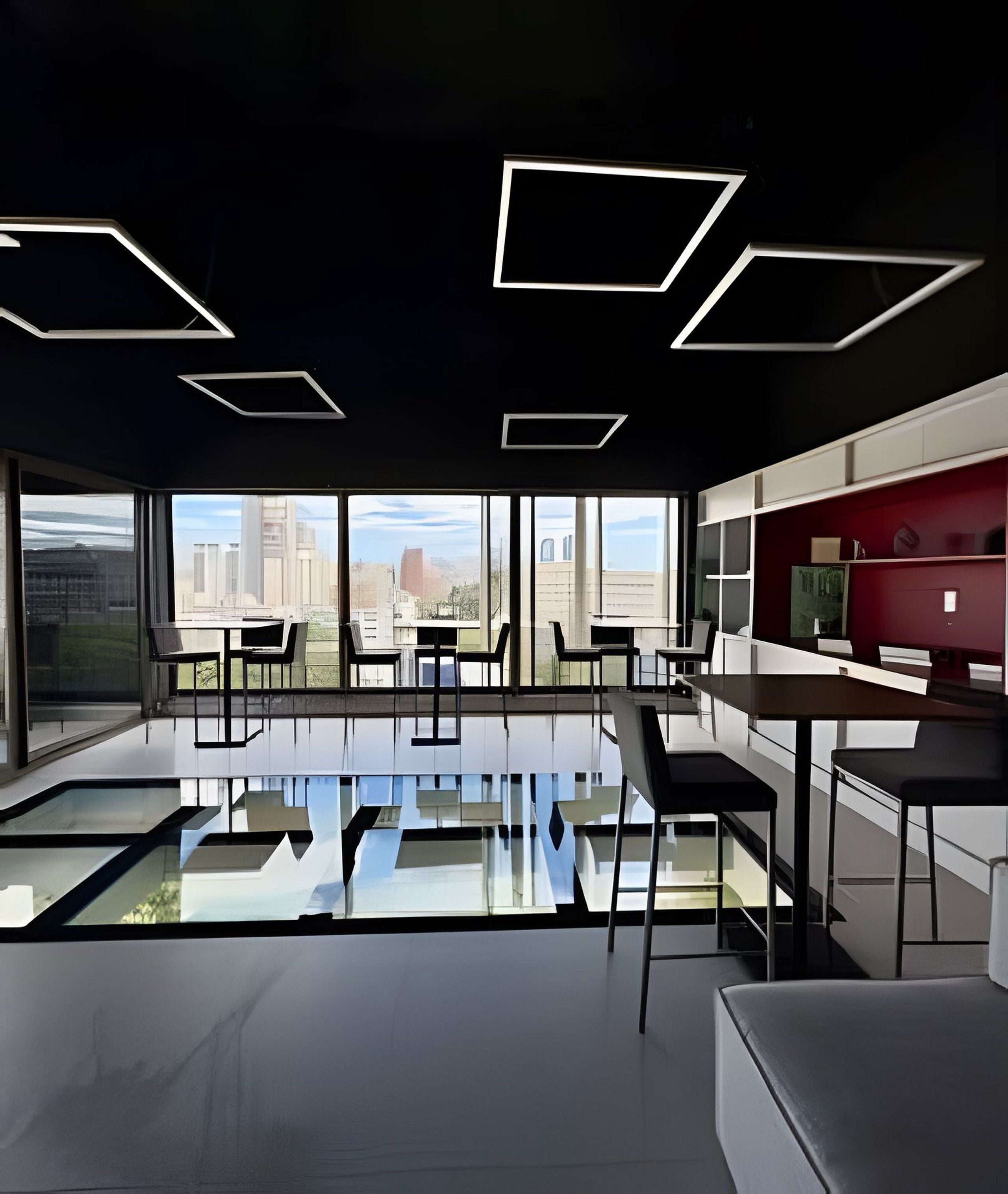 A modern interior with a glass floor, large windows, and a city view.