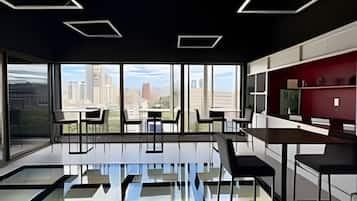 A modern interior with a glass floor, large windows, and a city view.