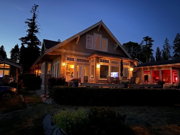 A two-story house with a covered porch and a garage.