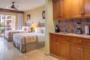 A hotel room with two beds, a kitchenette, and a balcony. - Junior Suite in Cabo San Lucas on Medano Beach with Amazing Views of the Arch! (Cabo San Lucas)